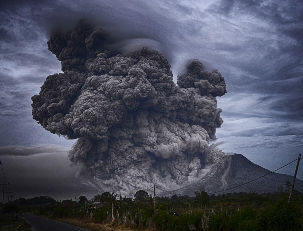 Volcano erupting with a cloud of ash