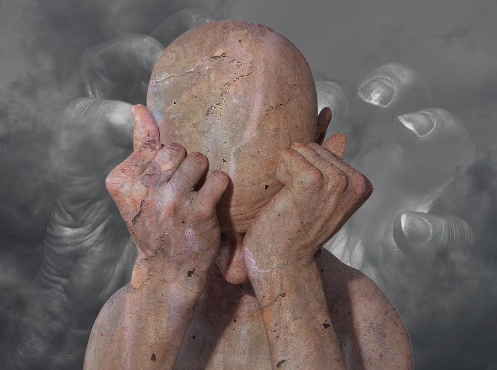 confused man with a hand clutching towards him behind